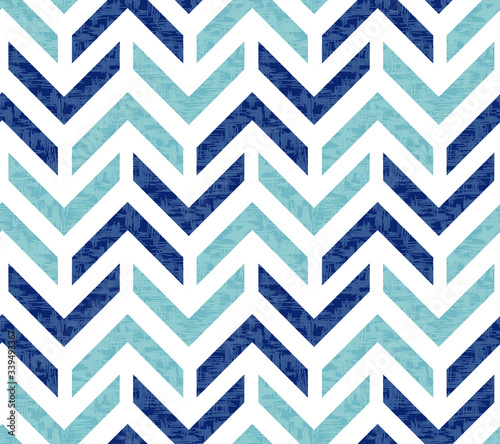 Abstract grunge chevron Ikat geometric seamless pattern. Blue zigzag waves on white background. Ethnic asian, indian, aztec fashion style. Fancy boho texture for fabric print, wallpaper, gift wrap.