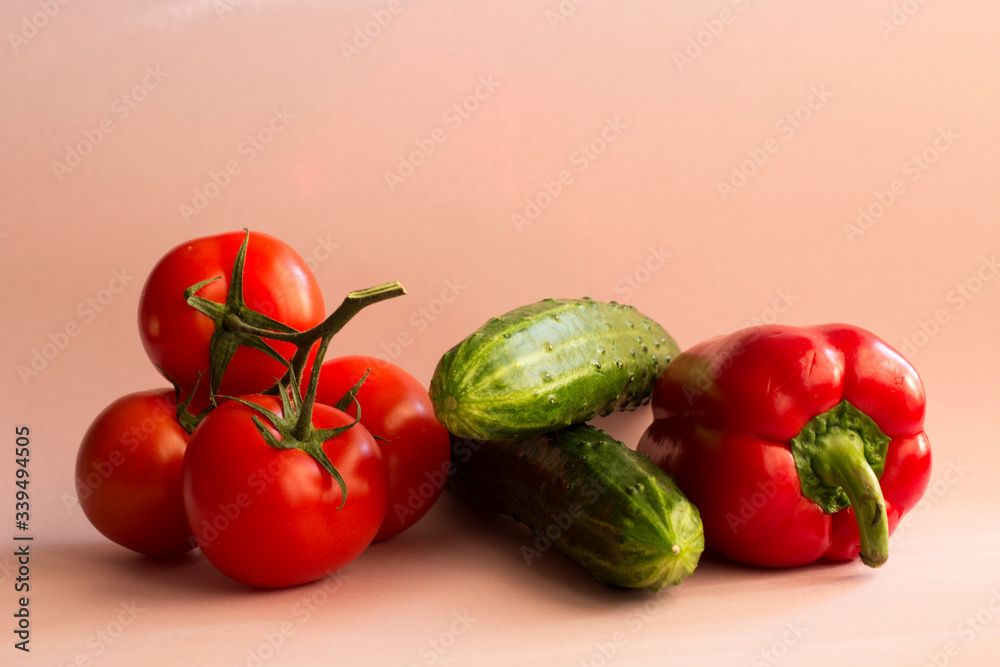 red pepper, tomatoes, red paprika and cucumber on a pastel pink background. Set of seasonal vegetables. The concept of a healthy diet red pepper, tomatoes, red paprika and cucumber on a pastel pink background. Set of seasonal vegetables. The concept of a healthy diet
