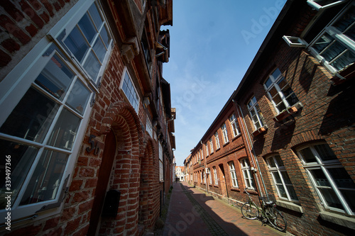 Ultra wide angle shot of a narrow alley of red brick houses in the interior of a northern German old town