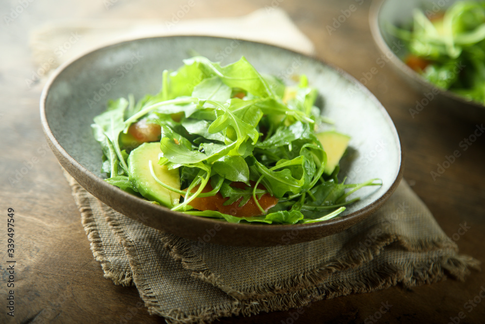 Healthy arugula salad with tomato and avocado Healthy arugula salad with tomato and avocado