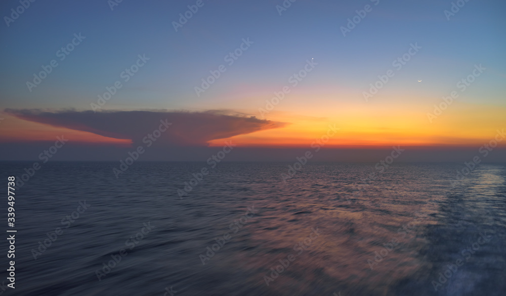 Unique unknown cloud object on vivid sunset seen from ferry boat travel trip from Java to Maluku, Indonesia
