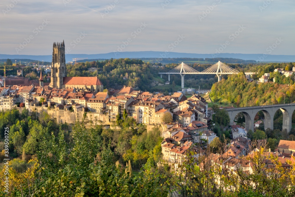 Panoramic view of cathedral of St. Nicholas, new Poya and old Zaehringen bridge by night, Fribourg, Switzerland, HDR