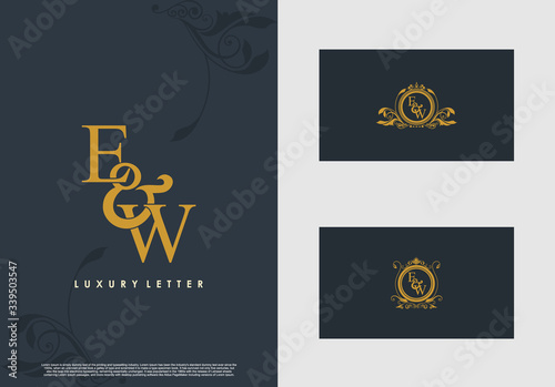 EW logo initial vector mark. Gold color elegant classical symmetric curves decor.