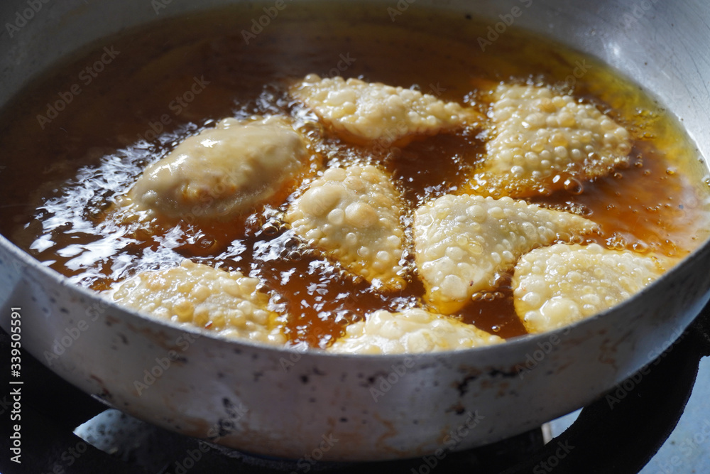 Deep firied Malaysia traditional chicken curry puff in the hot boiling oil. Deep firied Malaysia traditional chicken curry puff in the hot boiling oil.