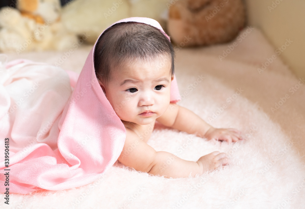 Close-up of unrecognizable cute baby shaking feet while lying in bed, innocence baby development concept Close-up of unrecognizable cute baby shaking feet while lying in bed, innocence baby development concept