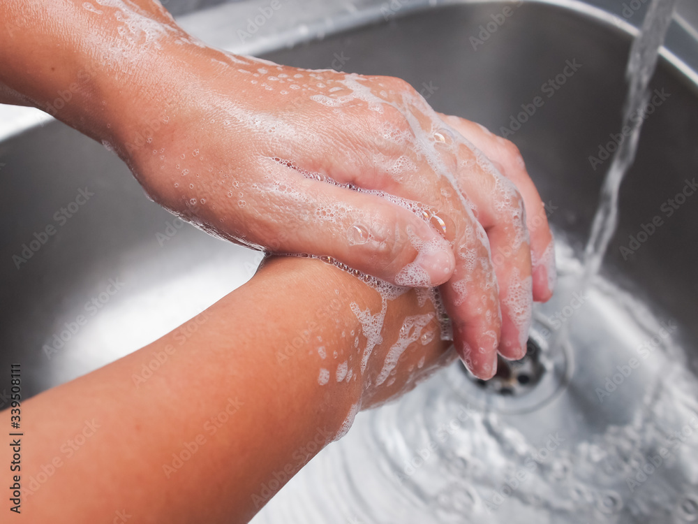 Image of a man washing his hands with soap to prevent corona virus.
Image of a man washing his hands with soap to prevent corona virus.