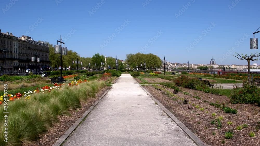Reflecting pool gardens at Place de la Bourse next to Le miroir d'eau and the Garonne river in Bordeaux France during the COVID-19 pandemic, Dolly forward shot Reflecting pool gardens at Place de la Bourse next to Le miroir d'eau and the Garonne river in Bordeaux France during the COVID-19 pandemic, Dolly forward shot