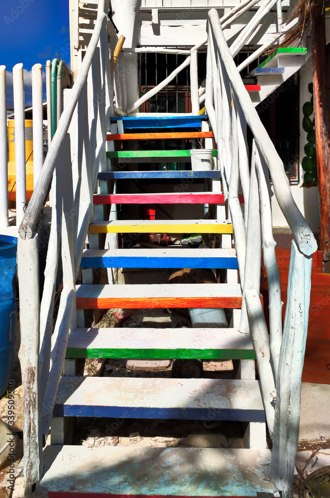 Wooden staircase with colored painted steps.