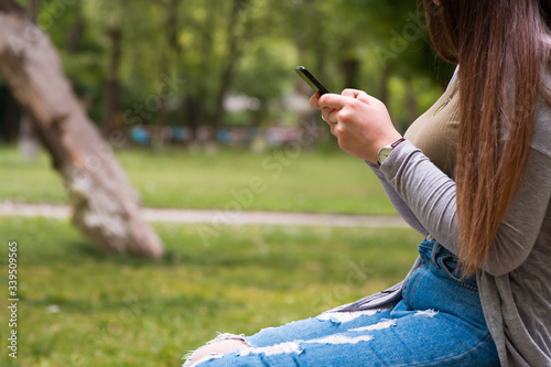 woman hand phone sitting in garden