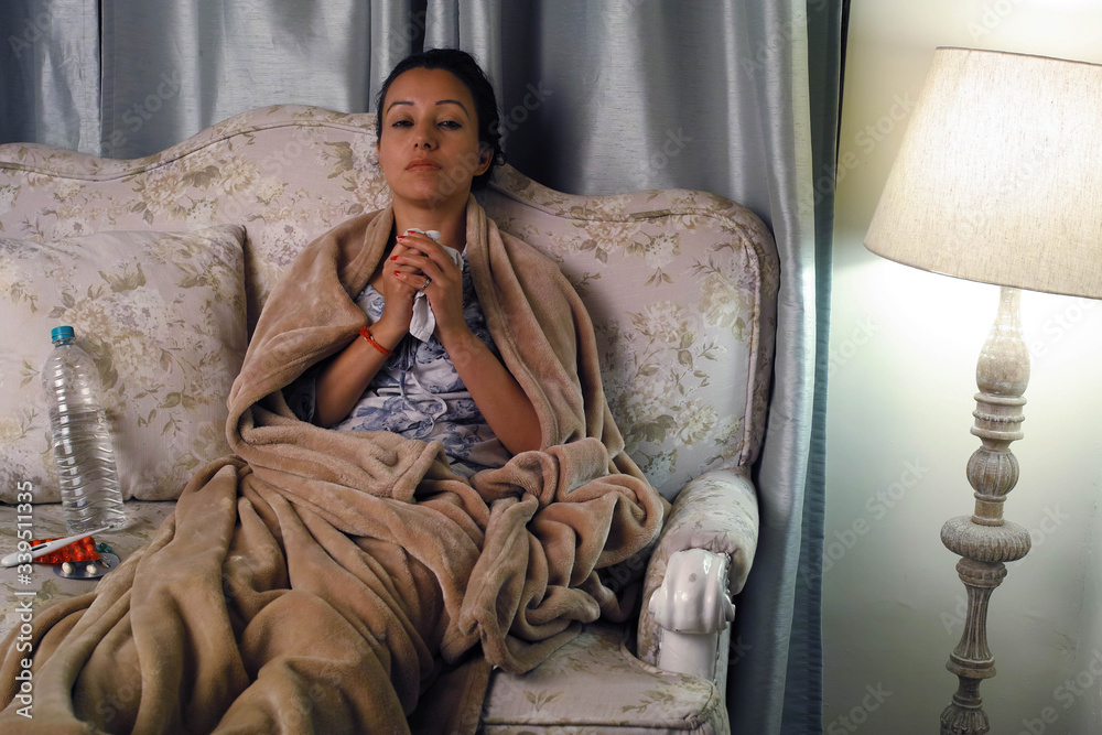Sick woman sitting on couch and relaxing. Sick woman sitting on couch and relaxing.