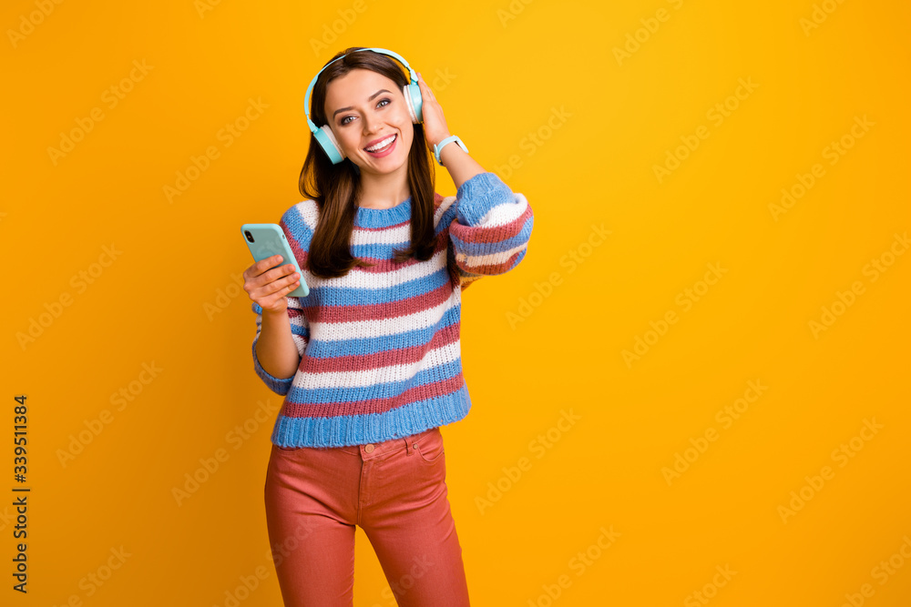 Portrait of her she nice attractive lovely cute cheerful cheery brown-haired girl holding in hands mp3 player listening stereo sound rock isolated on bright vivid shine vibrant yellow color background Portrait of her she nice attractive lovely cute cheerful cheery brown-haired girl holding in hands mp3 player listening stereo sound rock isolated on bright vivid shine vibrant yellow color background