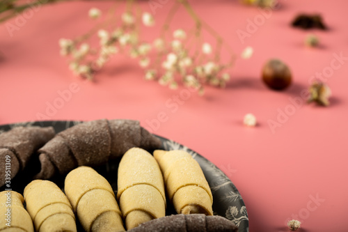 Traditional caucasian sweets mutaki made with vanilla and cocoa dough isolated on pink