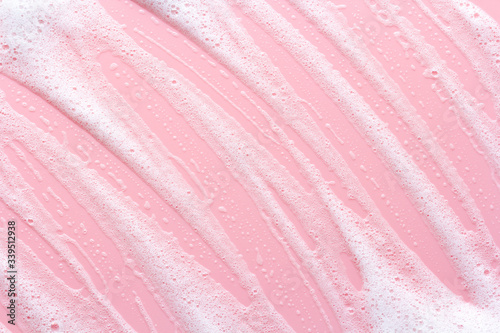 soap foam track on pink background, lather texture