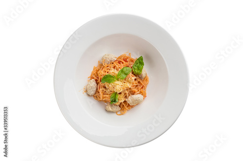 Chicken meatballs with pasta and tomato sauce on white plate isolated on white background