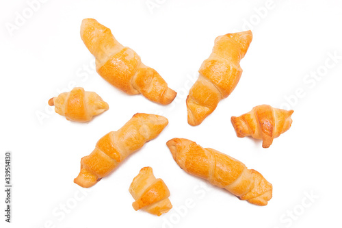 Croissants isolated on white background. Fresh homemade cakes. Buns, culinary composition.