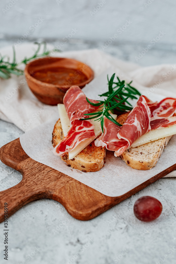 Slices of bread with spanish serrano ham served as tapas