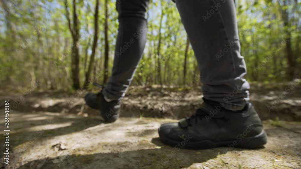 Hiking in the bright spring forest. Unrecognizable shoes close-up gimbal, steadicam smooth 4K. Hiking in the bright spring forest. Unrecognizable shoes close-up gimbal, steadicam smooth 4K.