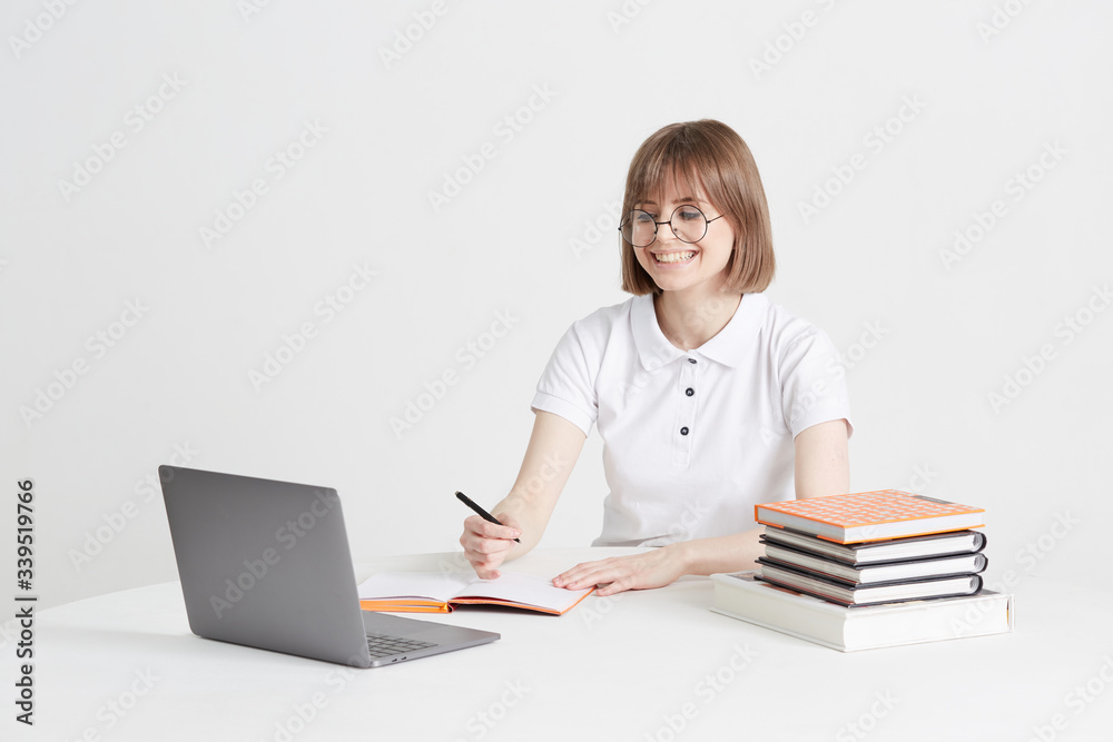 Cool happy girl goes through online training sitting at home. Remote school education on a laptop. Stay home lessons. Cool happy girl goes through online training sitting at home. Remote school education on a laptop. Stay home lessons.