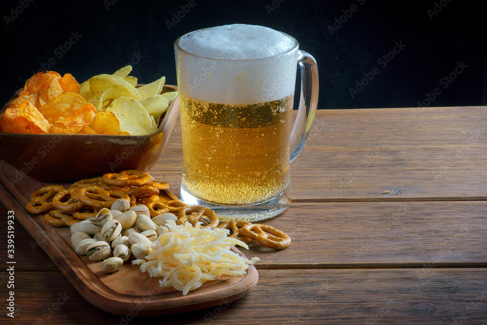 a glass of light beer with snacks a glass of light beer with snacks