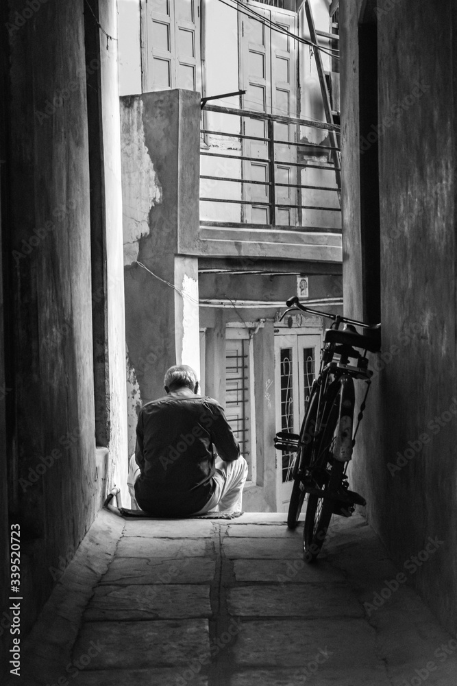it refers to old shadow of the person at certain age in old city India. It shows the mood of peace in little light 