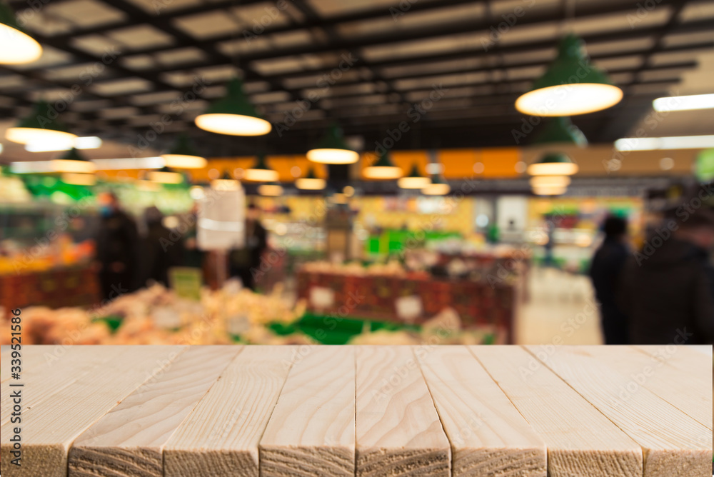 Supermarket background, Counter over blur grocery background, Wooden desk, table, shelf and blur woman shopping at supermarket, Wood counter for grocery store retail product display backdrop, template Supermarket background, Counter over blur grocery background, Wooden desk, table, shelf and blur woman shopping at supermarket, Wood counter for grocery store retail product display backdrop, template