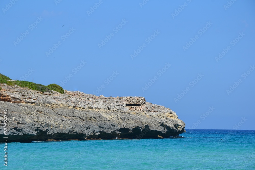 Fototapeta premium Landscape of the beautiful bay of Cala Estany d'en Mas with a wonderful turquoise sea, near Porto Cristo, Mallorca/Majorca, Spain