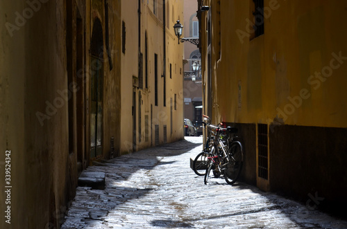 Sunny alley in Florence with bicycle