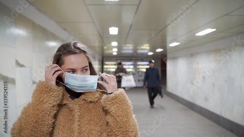 Coronavirus in Moscow, woman entering Moscow metro in medical face mask, COVID-19 Moscow life
