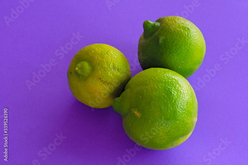 Isolated Mexican Lima, mousambi, common sweet lemon on a violet background, scientific name Citrus limetta
 photo