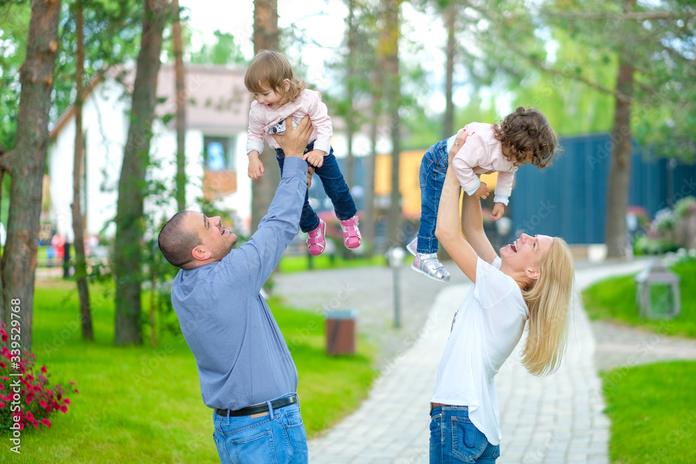 Fototapeta premium beautiful family walks in a flowered park