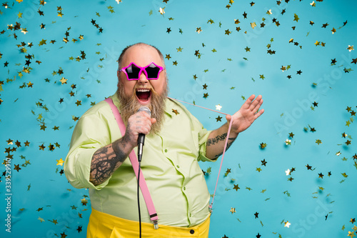 Close-up portrait of his he nice attractive cheerful cheery funky bearded guy having fun singing romantic pop hit isolated over bright vivid shine vibrant blue color background photo