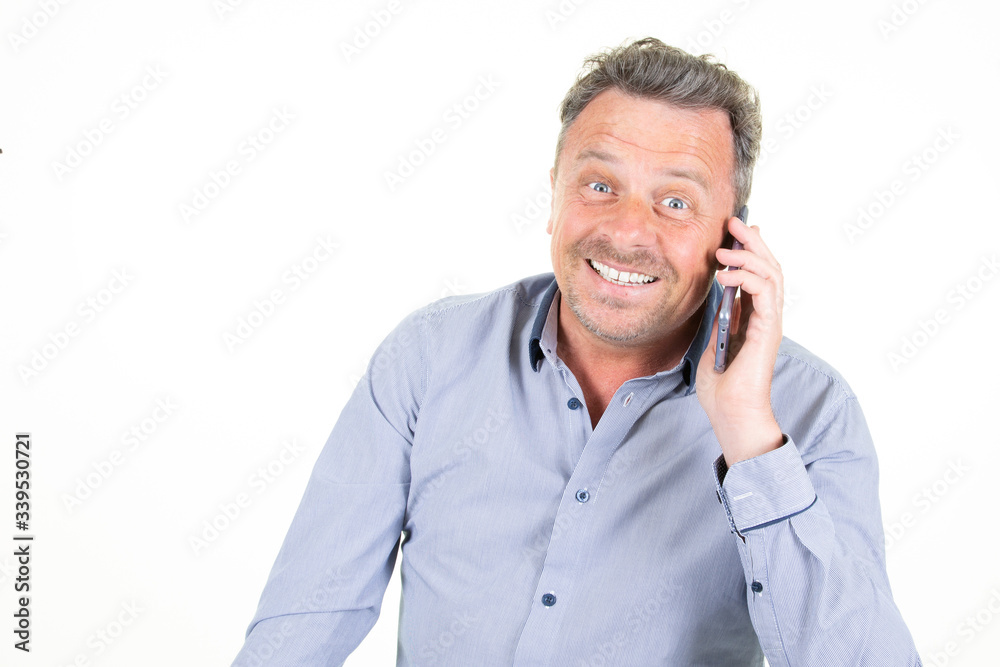 Smiling happy man talking on smartphone mobile phone isolated on white background