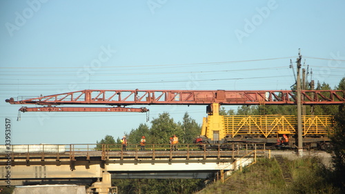 Russian rail stacker crane on a railway bridge, replacement of rails, repair of the trackbed