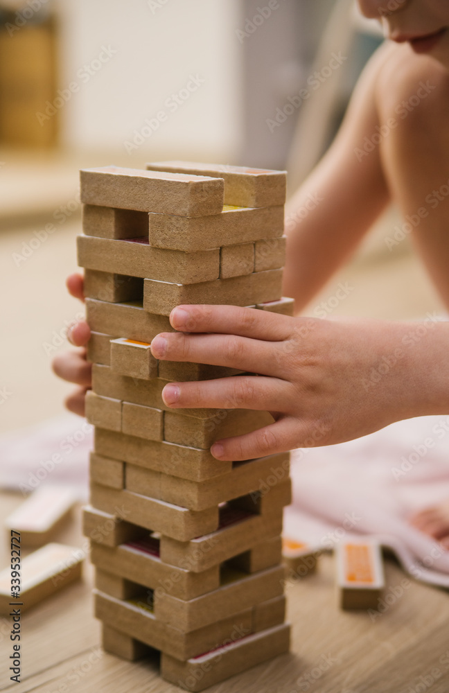 Tower Board game. Home entertainment. Wooden elements of the game. Sit at home. Tower Board game. Home entertainment. Wooden elements of the game. Sit at home.
