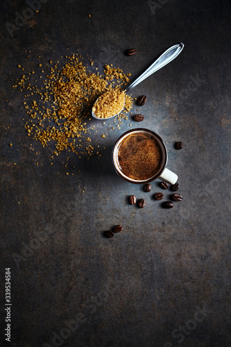 Cup of strong turkish coffee and cane sugar on rustic background. Copy space