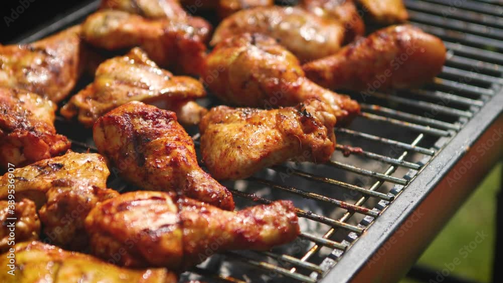 Delicious chicken pieces frying on barbecue grill Delicious chicken pieces frying on barbecue grill
