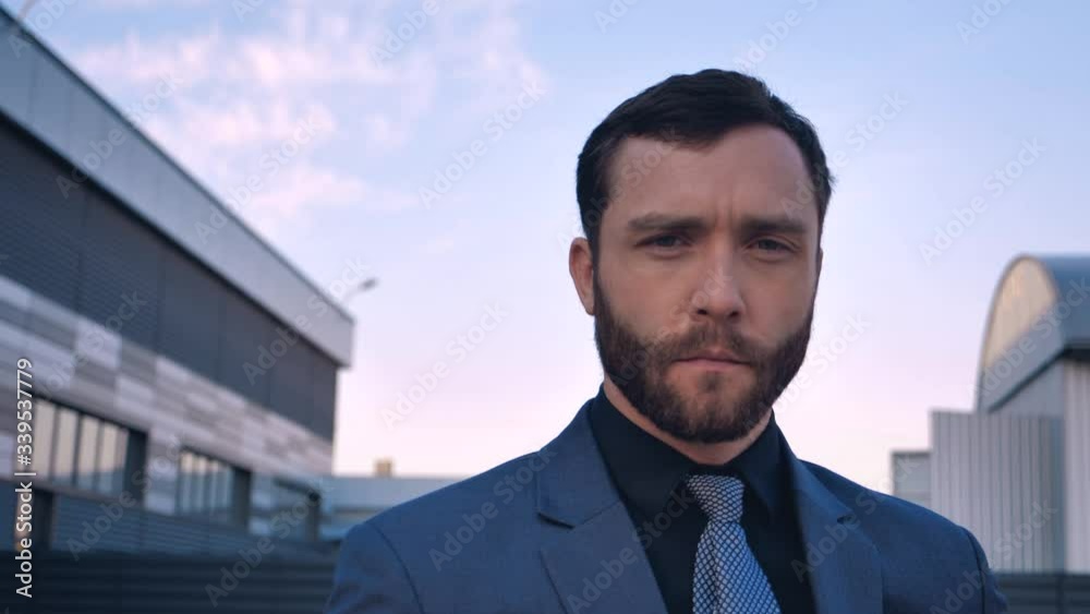 Portrait handsome Bearded BusinessMan in Suit standing near Modern Office Building Portrait handsome Bearded BusinessMan in Suit standing near Modern Office Building