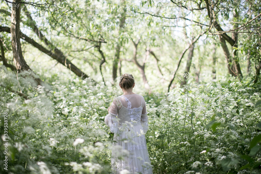 Woman walking through cow parsley in the countryside Woman walking through cow parsley in the countryside