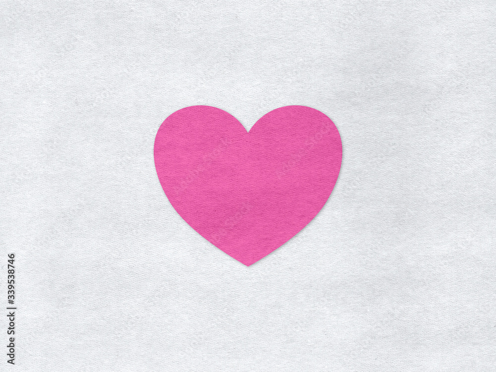 Pink heart on a grey paper background