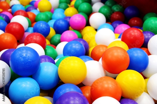 solid background lots bright multi-colored balls for dry pool, selective focus © Yuliya Zhuravleva