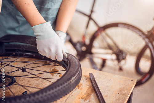 Bicycle tire care, Technician are fixing bicycle wheel, Close-up.