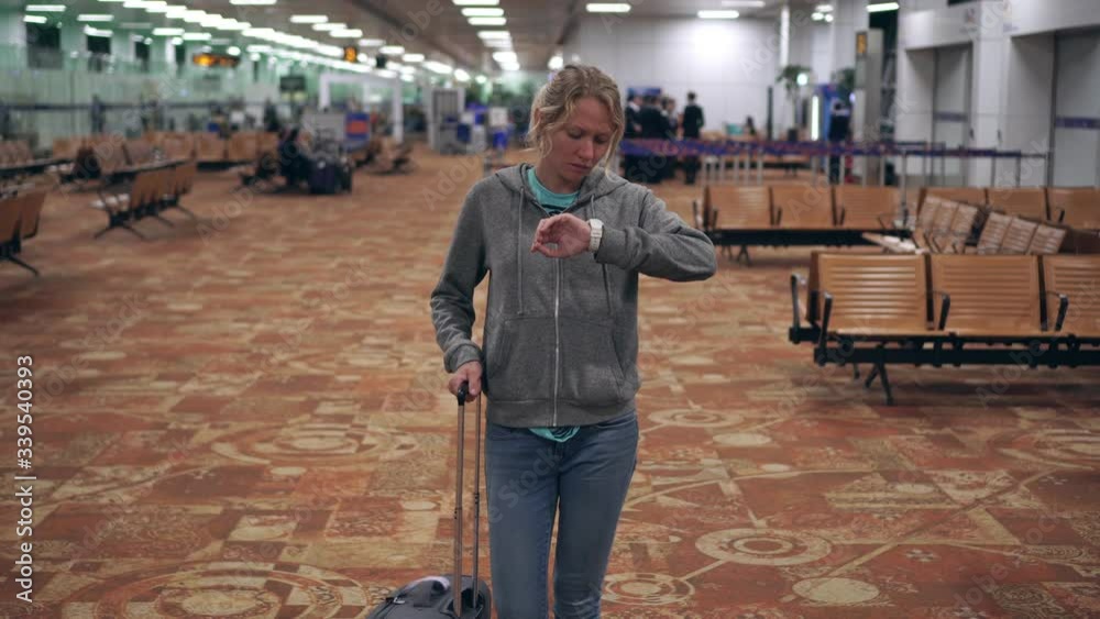 Young female tourist at the airport in the waiting room Young female tourist at the airport in the waiting room