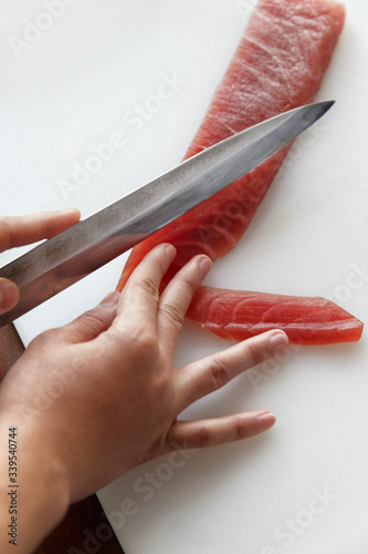 Chef cutting or slice tuna