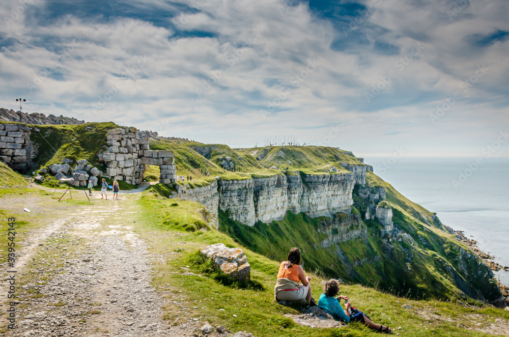 The coastal path along the cliffs of the Jurassic coast on the Isle of Portland, Weymouth, Dorset, UK on a warm, hazy and sunny Summer morning