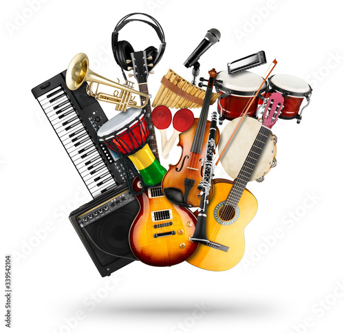 stack pile collage of various musical instruments. Electric guitar violin piano keyboard bongo drums tamburin harmonica trumpet. Brass percussion studio music concept isolated white background