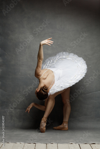 Fototapeta Naklejka Na Ścianę i Meble -  Young beautiful ballet dancer is posing in studio