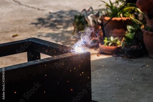 Workers welding metal in industrial plants