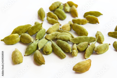 Grains of cardamom on a white background