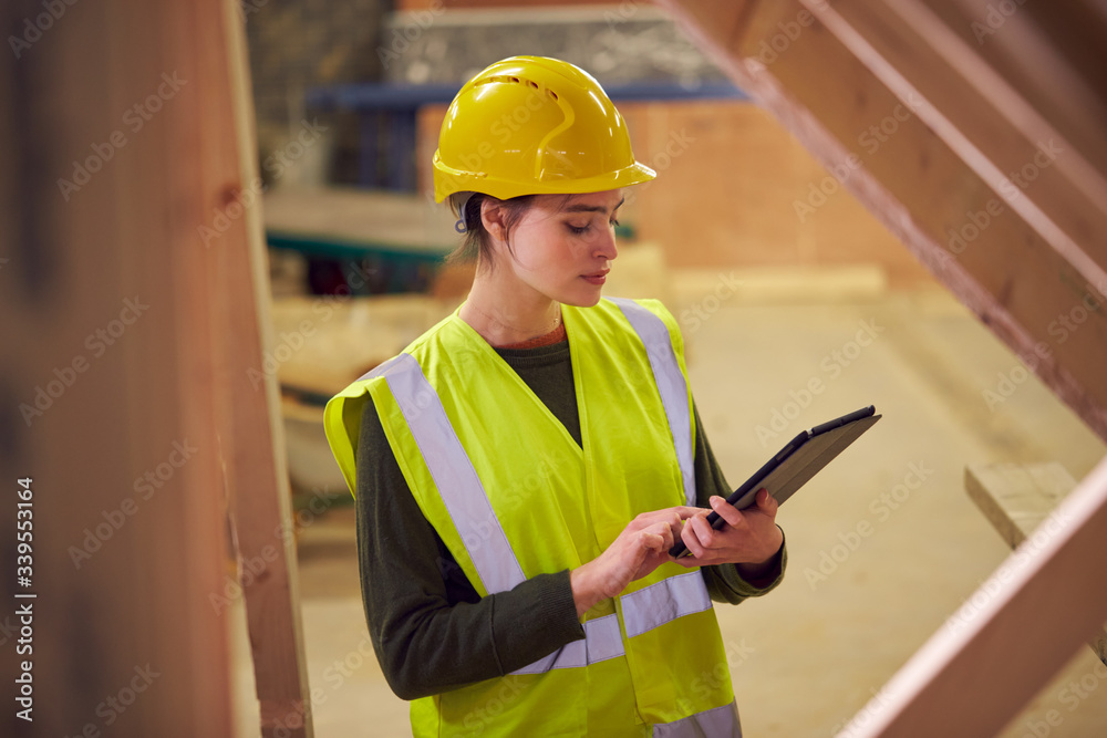 Female Safety Inspector With Digital Tablet At Construction Site Female Safety Inspector With Digital Tablet At Construction Site