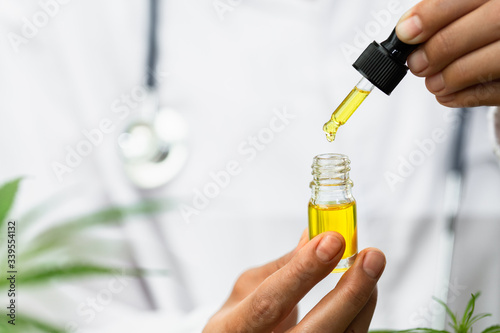 Drip hemp oil into a glass bottle. CBD oil. Cannabis. Alternative medical concepts. Scientific research. Medical education and research.